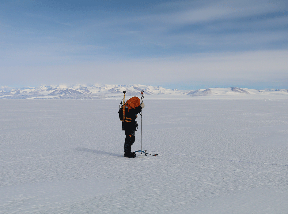 Lead author Antonia Radlwimmer uses a magnaprobe to measure snow depths on the sea ice in McMurdo Sound in November 2024. Photo: Inga Smith
