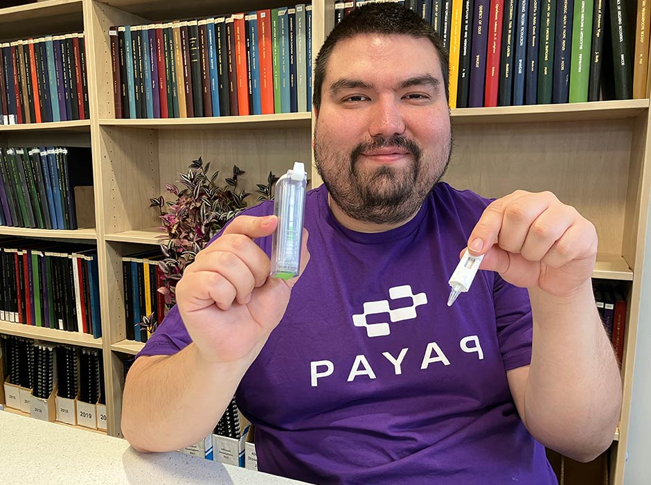 Graduand Benjamín Durán-Vinet  with a portable testing device incorporating the biosurveillance platform he integrated to detect species ranging from invasive pests to endangered species. 