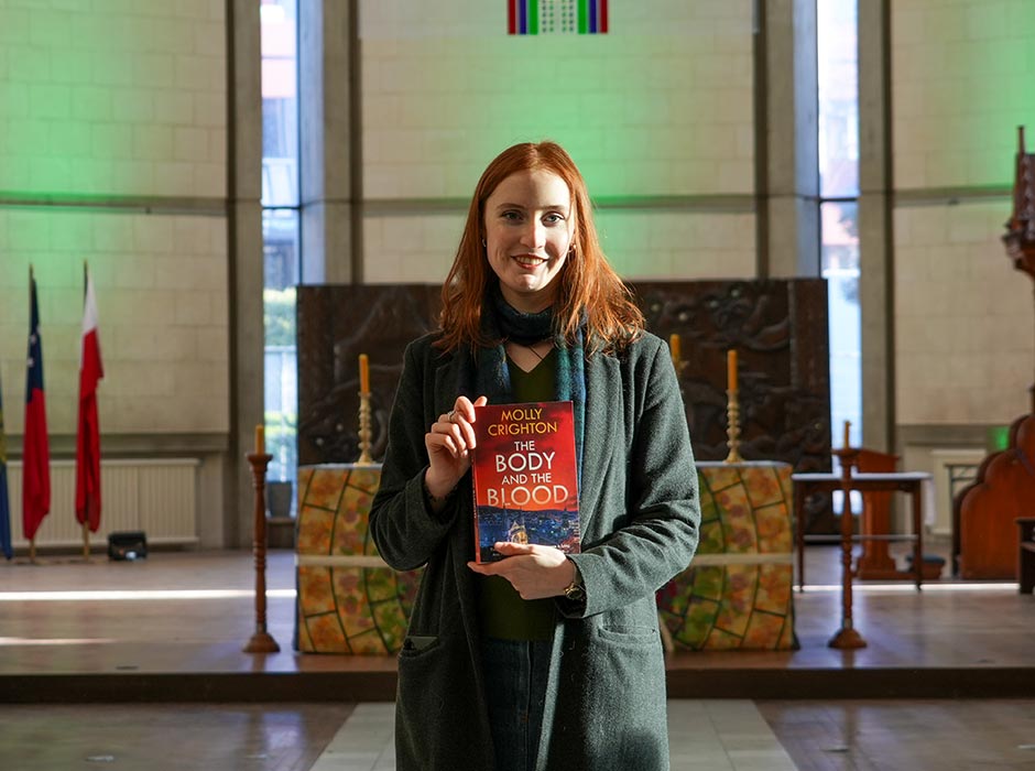 Author Molly Crighton pictured holding her book inside St Paul's Cathedral.
