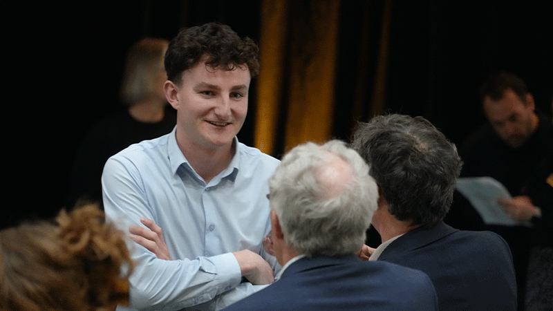 man talking to other people