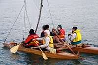 Group of people paddling in a small waka image.