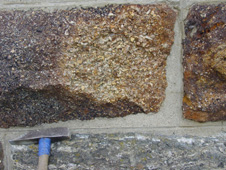 Blocks of Eocene (40 million years old) Hogburn Formation quartz gravels (top and right) in a bridge of the Otago Central Rail Trail at Tiroiti, north of Hyde. The gravels have been cemented by iron oxyhydroxide produced from weathering of pyrite (FeS<sub>2</sub>). These gravels rest on the basement unconformity on schist (lower block). The Waipounamu Erosion Surface and associated marine sediments occur immediately above the gravels in nearby outcrops