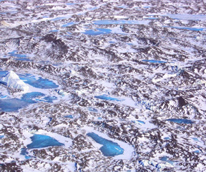 These moraine pinnacles accumulate on the ice shelf surface from basal adfreezing of relict moraines on the McMurdo Sound floor which are transported to the ice surface by ablation.