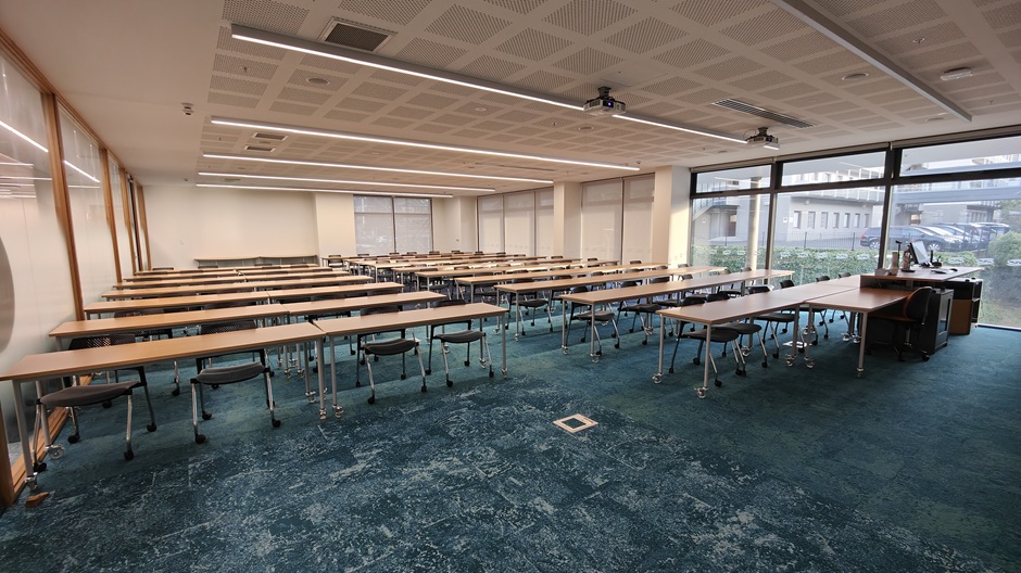 View of Otago Business School room 117, showing rows of tables and chairs