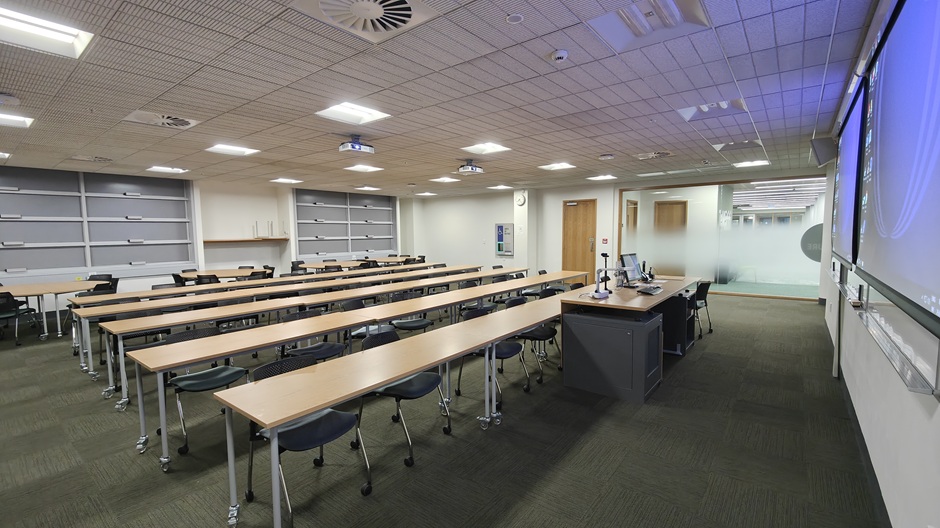 View of Otago Business School room G02, showing tables and chairs in rows and groups
