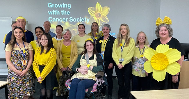 a group of people wearing yellow for daffodil day 