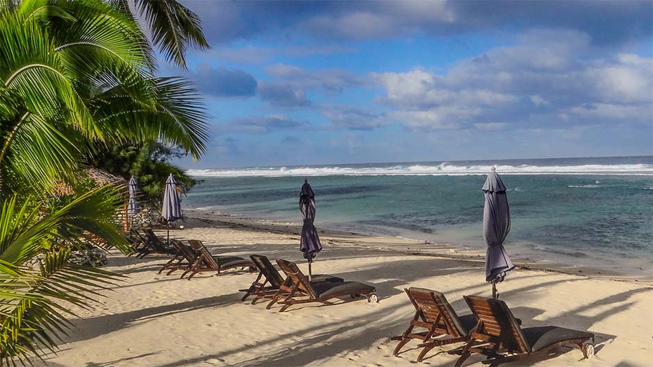Several pairs of chairs and sun umbrellas on a beach