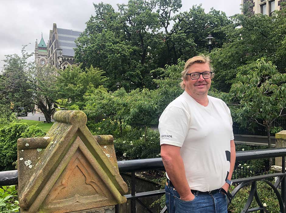 a man standing in front of a hand rail on a bridge 