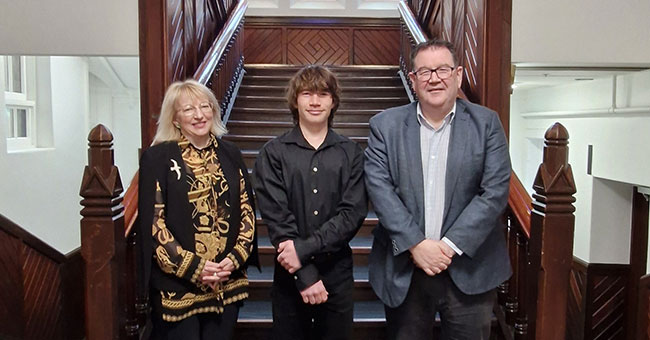 Posing for a photo in the Clocktower building are Mayor of Dunedin Sophie Barker, student Alexander Lea, and Otago Vice-Chancellor Grant Robertson