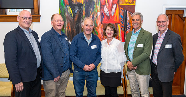 Five men and one woman pose for a photo at an event to celebrate the new Centre.