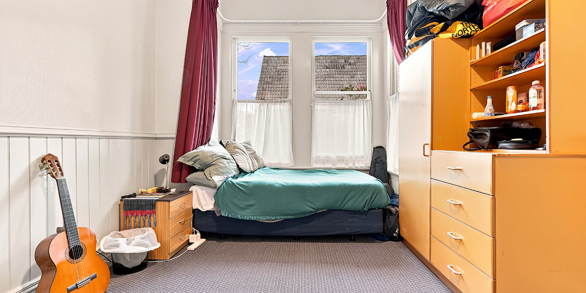 Student bedroom wih desk and wardrobe