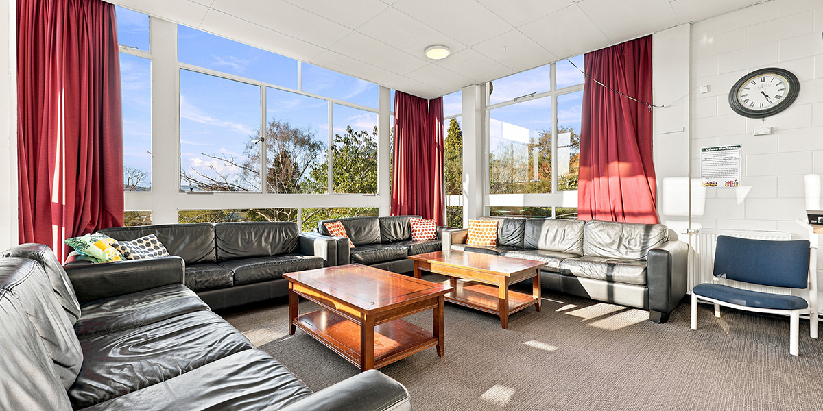 Lounge room with leather couches and coffee table