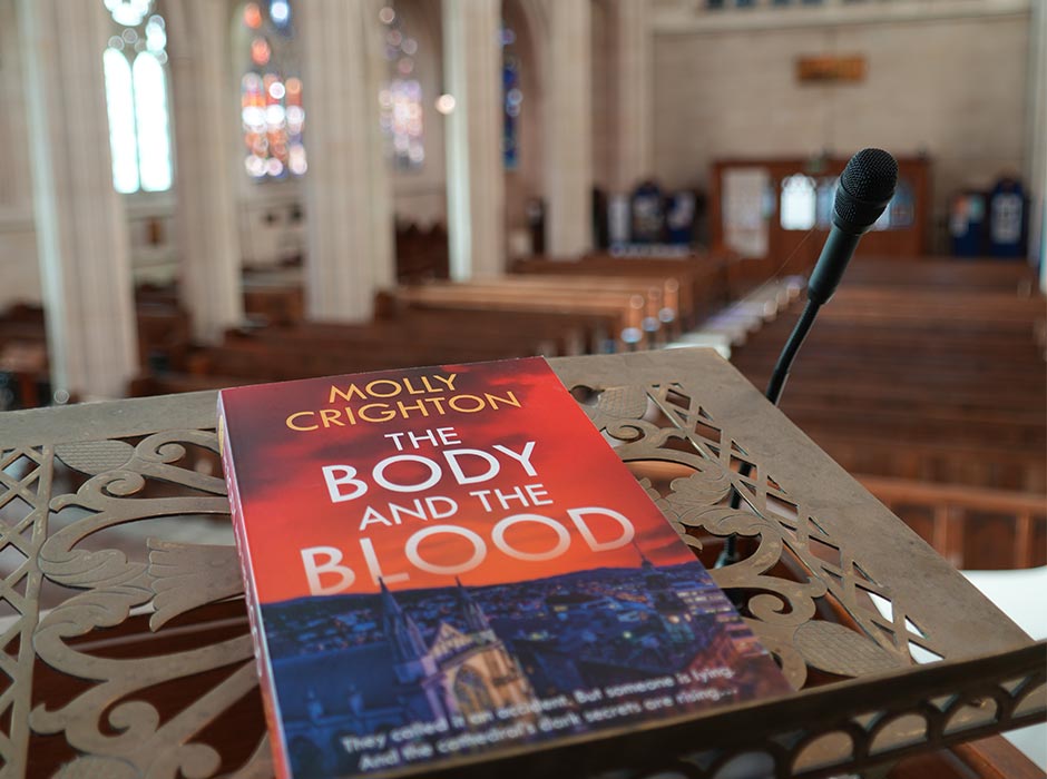 A crime novel is pictured inside a cathedral.