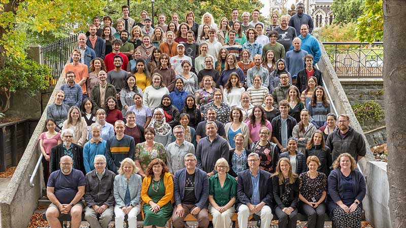 Roughly 10 rows of people standing on stairs for a photo
