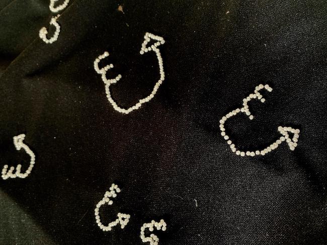 Close up view of beaded motifs on Emma Muir's dress