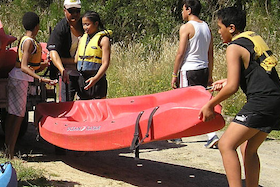 Young people prepare for a boating activity image