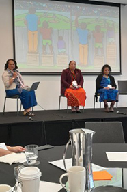 Dr Telesia Kalavite sitting on stage on the panel for academics