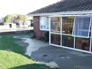 Sand boils adjacent to a house in Christchurch. These result from liquefaction of alluvial soils with shallow groundwater tables. Photo by Mark Quigley, University of Canterbury. 