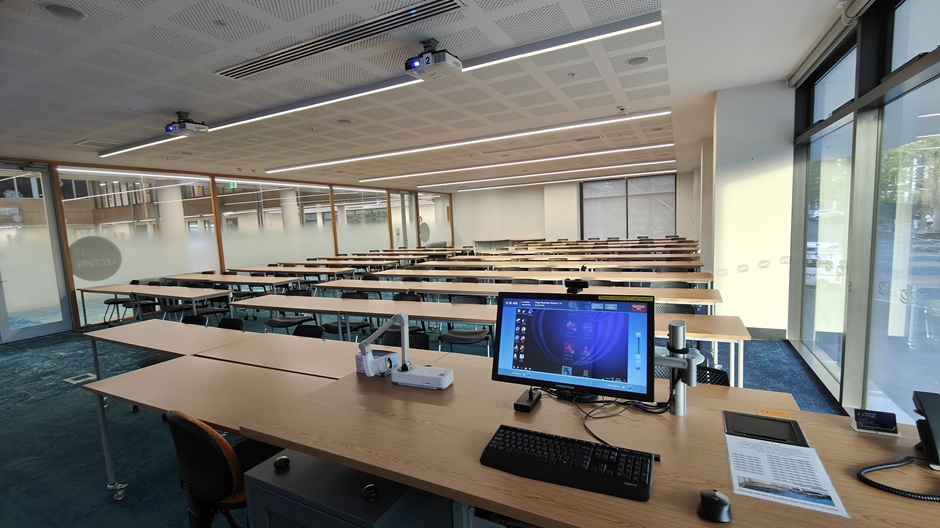 View of Otago Business School room 117, showing rows of tables and chairs