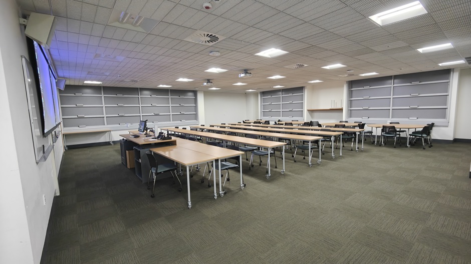 View of Otago Business School room G02, showing tables and chairs in rows and groups