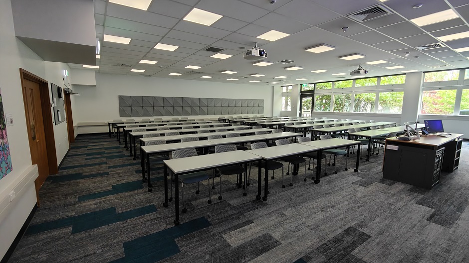 View of Biochemistry seminar room BIG13, showing rows of tables and chairs