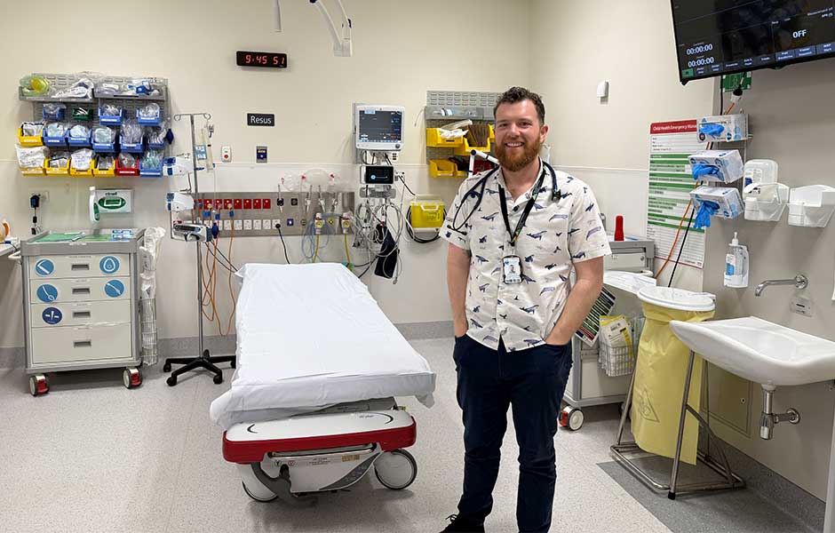 A standing next to a hospital bed 