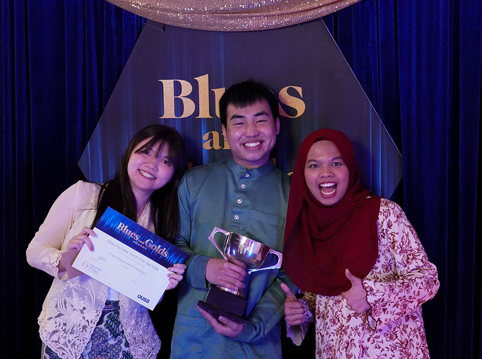 three people standing on stage 