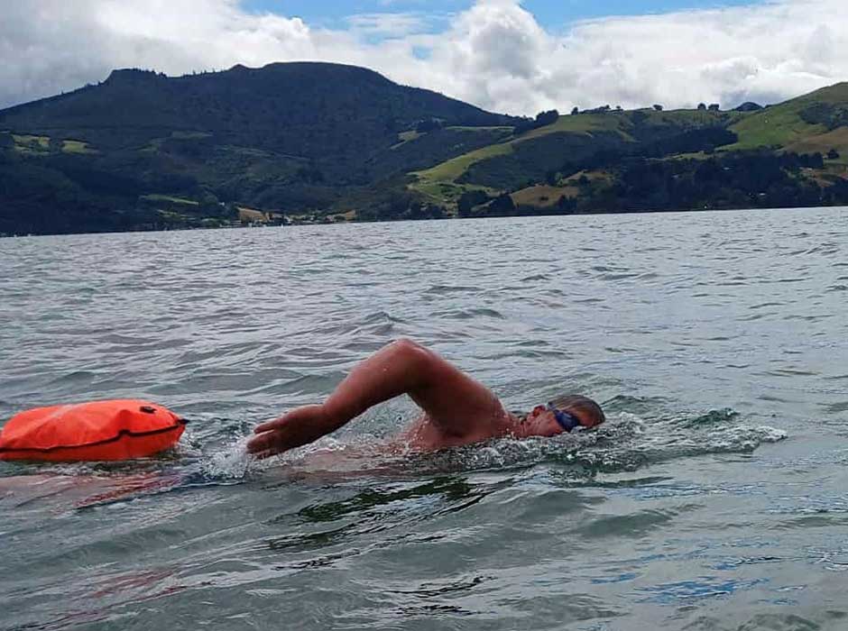 A man swimming in the harbour