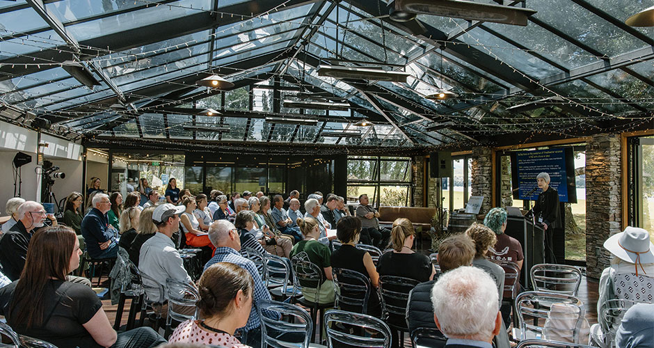 people seated with a person speaking in front of them 