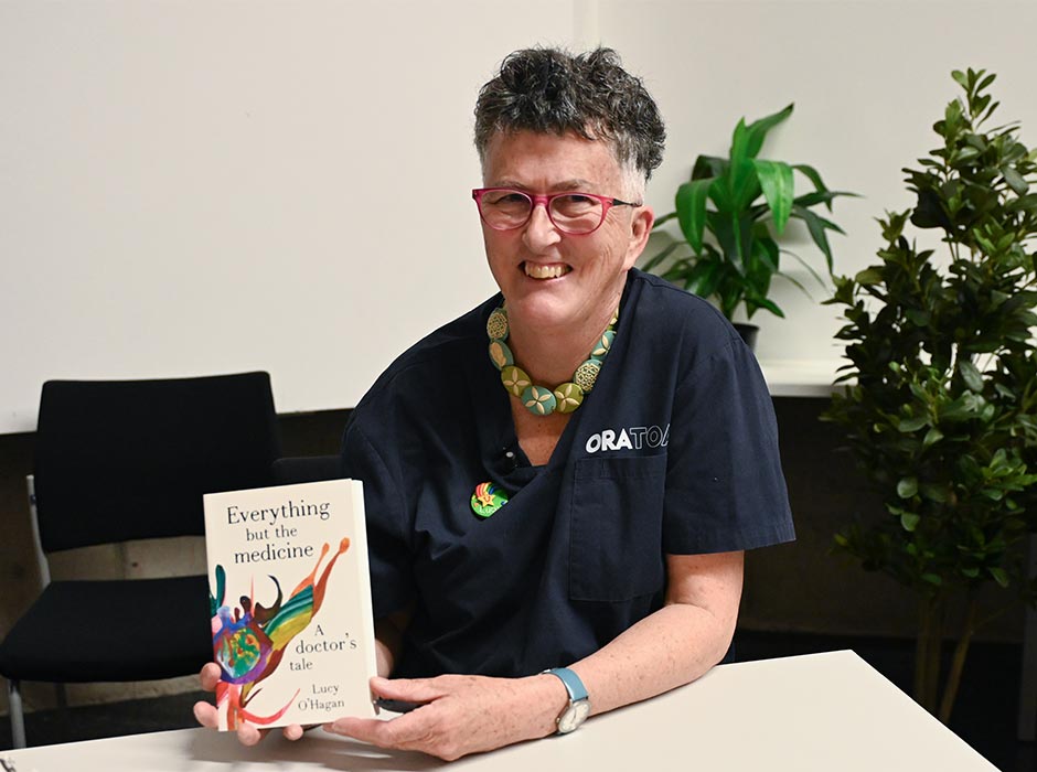 A woman holds a book.