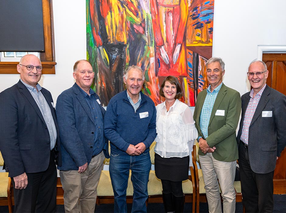 Five men and one woman pose for a photo at an event to celebrate the new Centre.