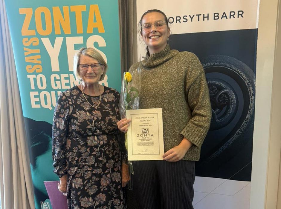 Two women are pictured holding a certificate.
