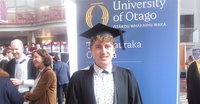 Reuben Beard, pictured in his graduation gown at the Business School.
