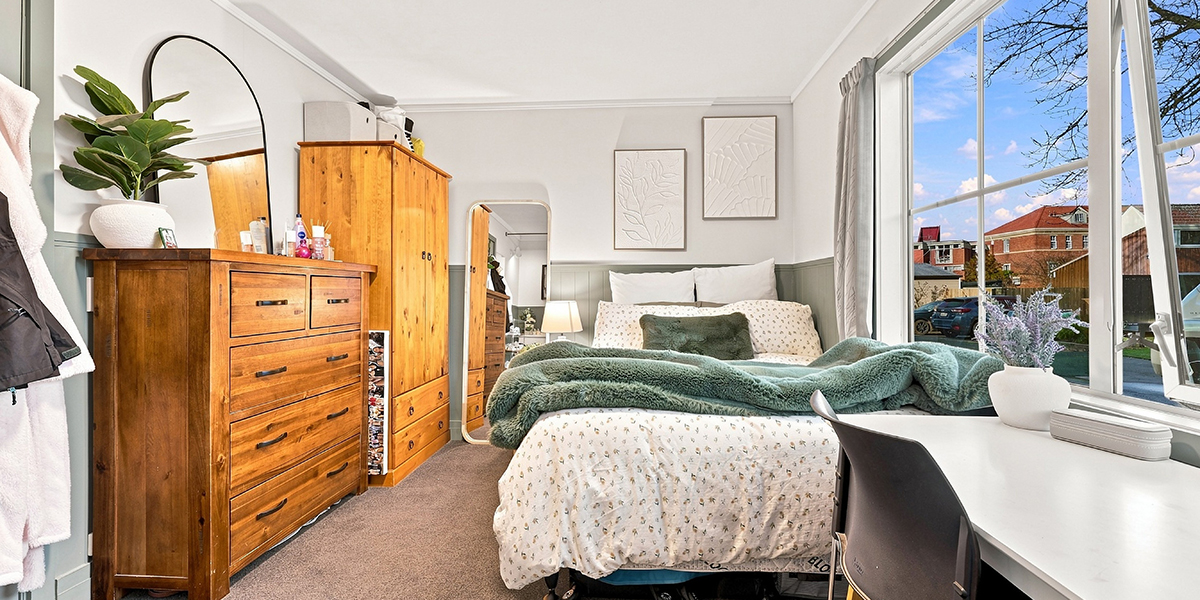 Student bedroom with wooden wardrobe and cupboard