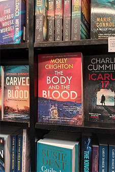 A bookshelf displaying crime novels.
