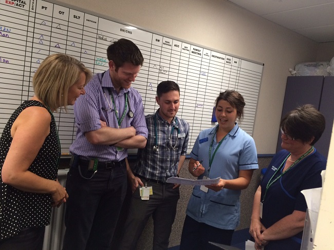 Medical staff discussing patient notes