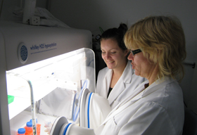 Gabi Dachs and Lizzie Campbell working in the lab