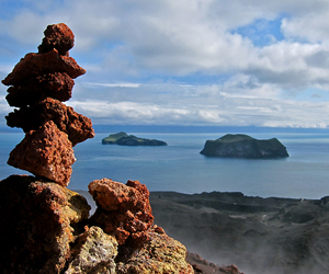 Heimaey Island, South of Iceland. The rocks in the foreground are from this recent eruption, while volcanic islands in the background were formed millions of years ago.