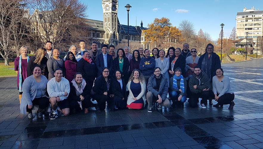 Group photo of Pacific staff taken with the Clocktower in the background.
