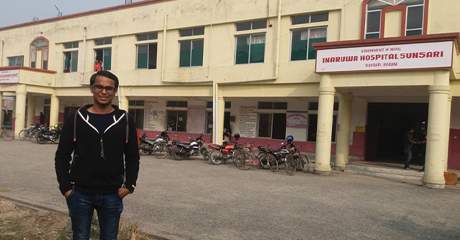 Roshit Bothara standing in front of a hospital in Nepal 