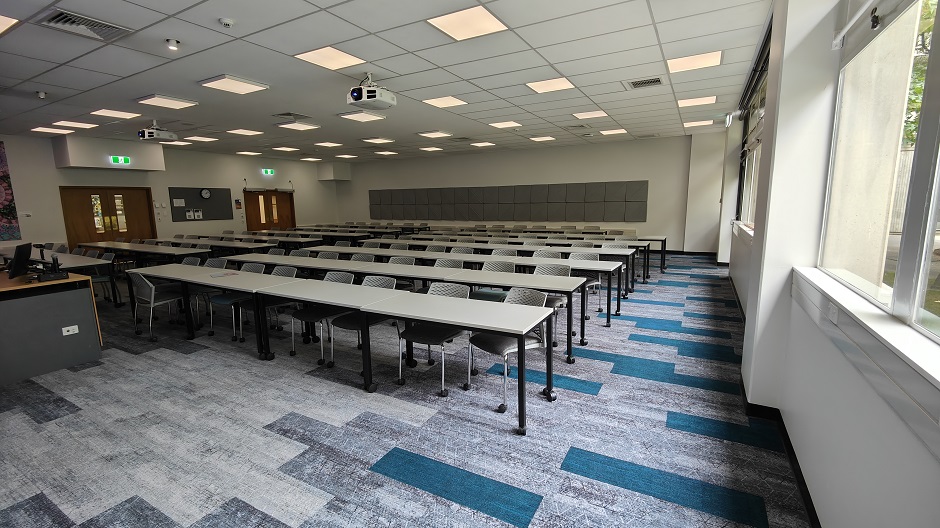 View of Biochemistry seminar room BIG13, showing rows of tables and chairs