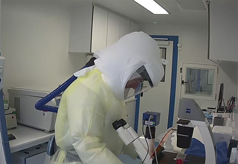 Dr Harfoot wearing full personal protective equipment while working inside the PC3 lab.