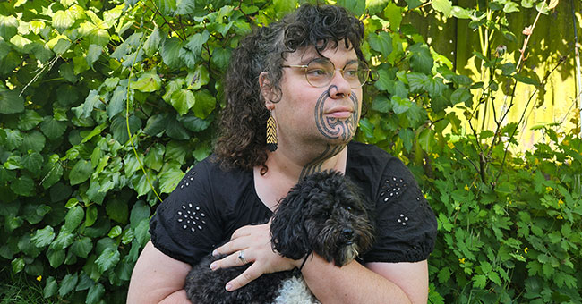 Image of graduand holding their dog.