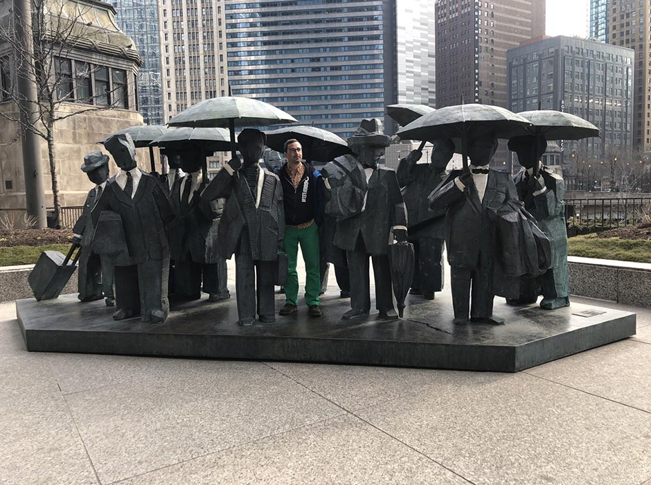 A man standing amongst the sculptures of men