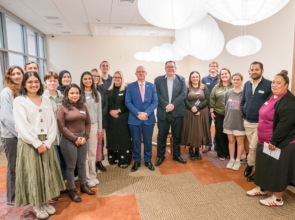 A group of staff and students gather for a photo in the new wellbeing hub.