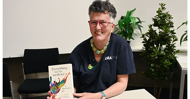A woman holds a book.