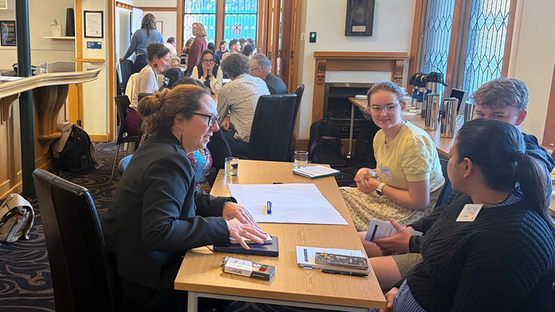 Groups of people at tables having discussions