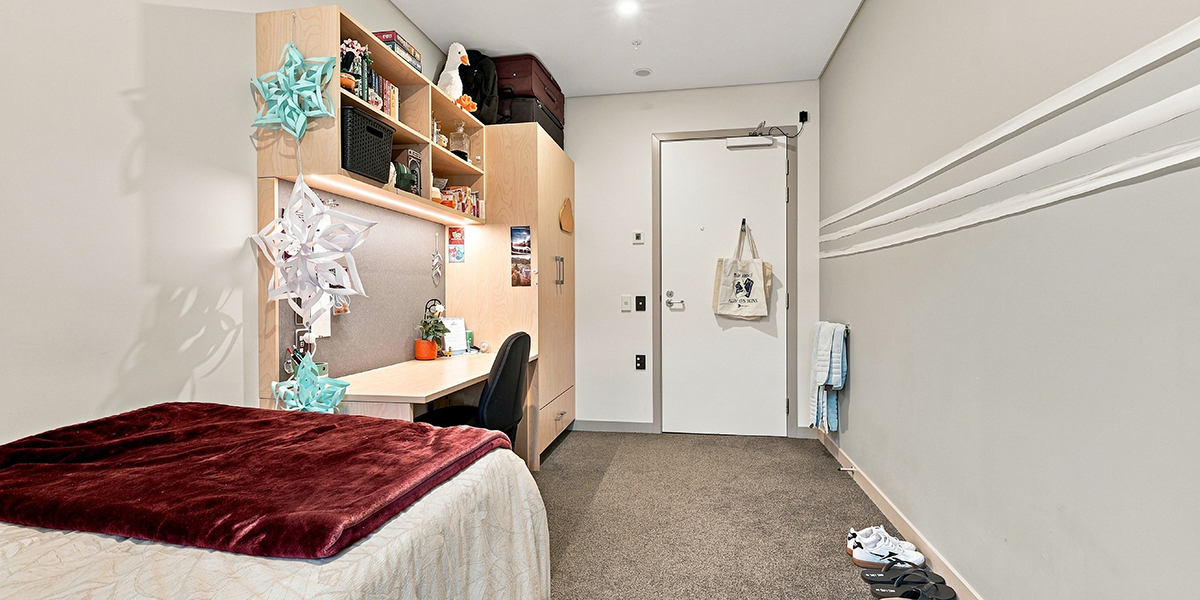 Student bedroom view from window towards door