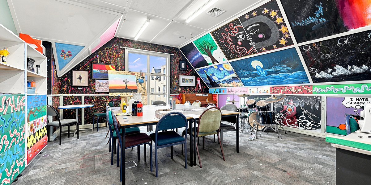 Art room with drum kit and art work on the walls