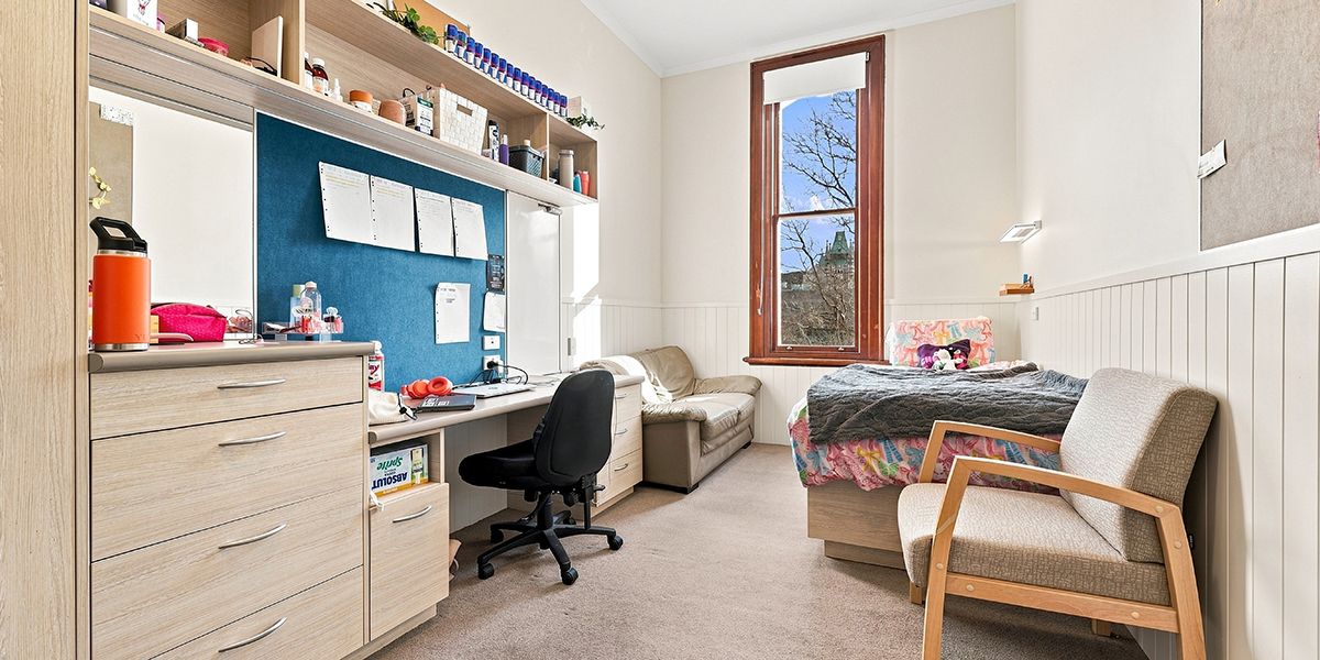 Student bedroom with sofa, desk and storage